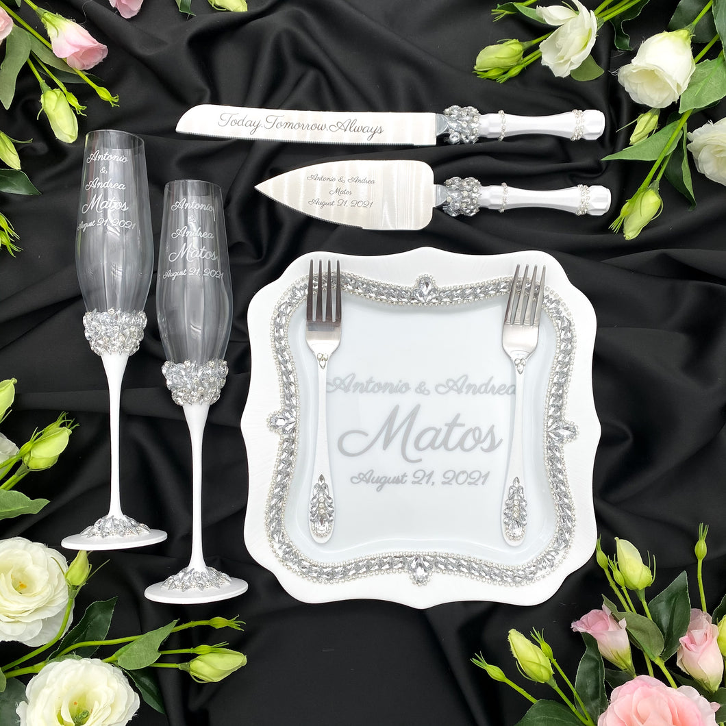 White wedding glasses for bride and groom, cake knife and server, wedding plate and forks